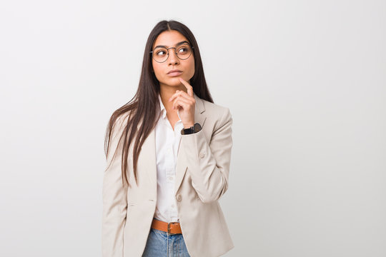 Young business arab woman isolated against a white background looking sideways with doubtful and skeptical expression.