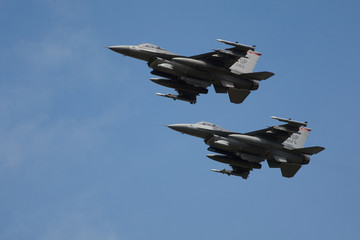 Two F16 Fast fighter jets fully loaded in formation flypast