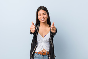 Young natural and pretty arab woman with thumbs ups, cheers about something, support and respect...