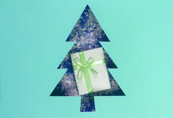 Geometric flat lay. Christmas artificial snow in a triangular paper hole in the shape of a...