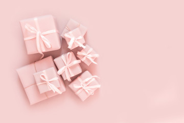 Christmas pink flat lay. Holiday boxes, fir branches on pink background. Christmas winter holiday...