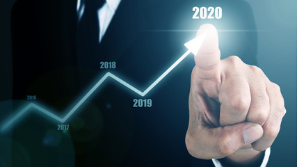 Man standing and pointing pen with Arrow and Line Visual Graphic on Light of Len flare and Bokeh blue background. COPY SPACE. Business Concept : Market Uptrend. Blue mood and tone. Forcast 2020.