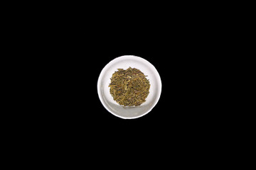 stock image of green tea dry on bowl isolated black background