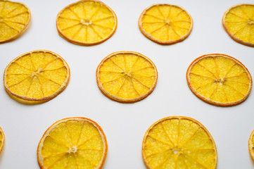 Fototapeta premium fruit pattern of a row of dried orange slices on a white background