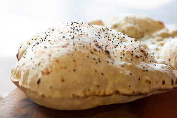 Fresh hot airy bread in a cafe. Airy hot oriental bread close-up, lies on a table in a cafe.