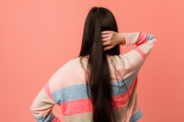 Young cool chinese woman from behind thinking about something.