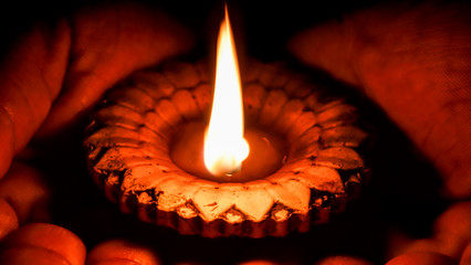 Lotus ,Hands hold terracotta oil lamp,Man hands holding a burning lamp in dark. male hands holding...