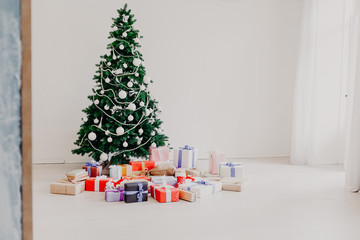 Green Christmas tree with gifts of toys for the new year holiday decor winter © dmitriisimakov
