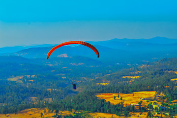 Summer mountain valley paragliding scene,Paragliding pilots focus on sky flight in saputara india,ountain valley paragliding,paragliding on the mountains