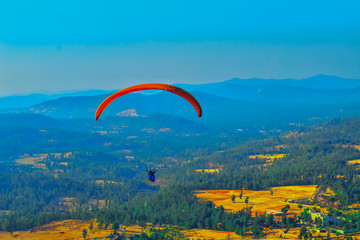 Summer mountain valley paragliding scene,Paragliding pilots focus on sky flight in saputara...
