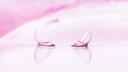 Tools for vision correction. Glasses and lenses with diopters on the background of splashes and blurry.