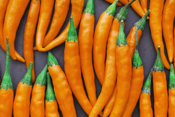 Hot orange pepper. Chilean pepper on a black.