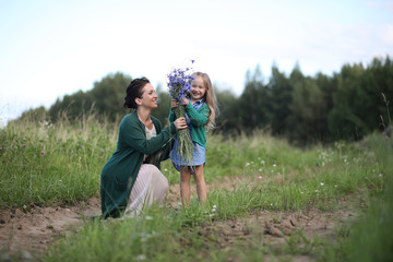 Mother with daughter walking on a road