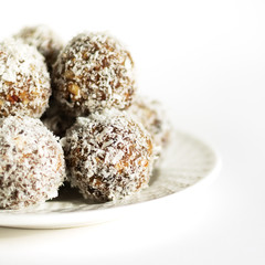 Energy balls on a white bowl on a white background