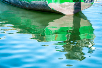 Boat with reflection in water at Lac Naila.