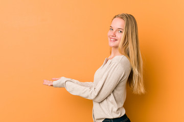 Cute and natural teenager woman holding a copy space on a palm.