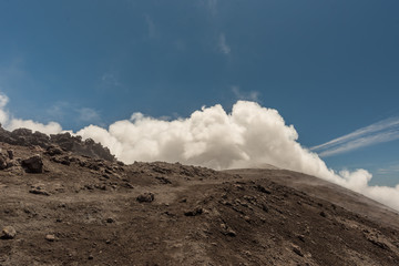 People walking on Mount Etna, active volcano on the east coast of Sicily, Italy. Panorama of Mount...