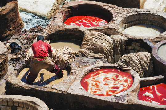 A man works in the tanneries of Fez, Morocco.