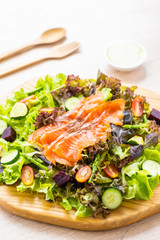 Raw Smoked salmon meat fish with fresh green vegetable salad