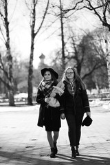 Fototapeta premium Black and white photo of a young girl on a walk