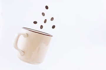 cup and coffee beans on white background