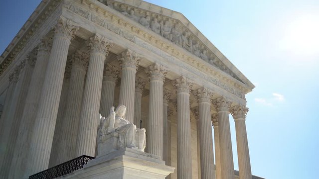 Supreme Court building and sculpture of Contemplation of Justice in Washington DC.