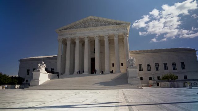 Wide camera motion to right of west facade of the Supreme Court building in Washington, DC.