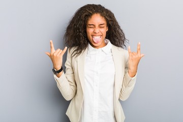 Young african american business woman showing rock gesture with fingers