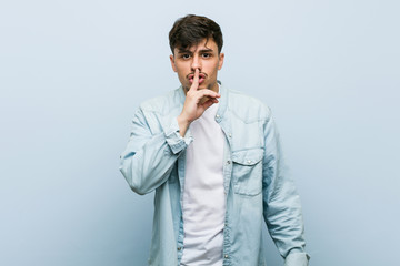 Young hispanic cool man keeping a secret or asking for silence.