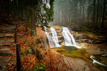 Beautiful Mumlavsky waterfall in long exposure during autumn in Harrachov, Giant Mountains, Czech republic