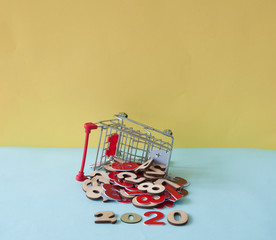 a shopping cart and heap numbers on colorful background