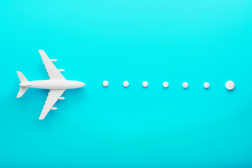 White plane on a blue background with a flexible and smooth trajectory of the route from white points.