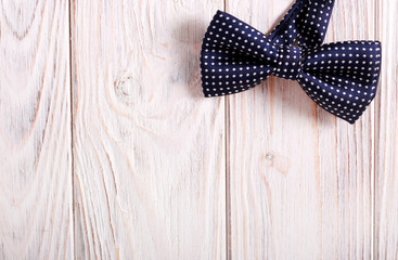  bow tie over light wooden background