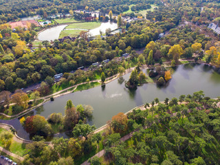 Aerial view above the park with pond and forest around. Boulogne, Paris, France