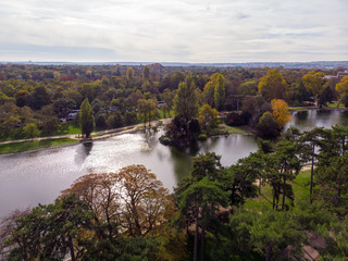Fototapeta na wymiar Aerial view above the park with pond and forest around. Boulogne, Paris, France