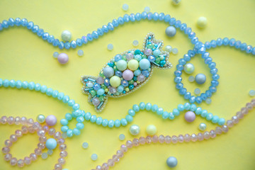 Handmade candy brooch in pastel colors, fashion jewelry, girl and women accessory on yellow...