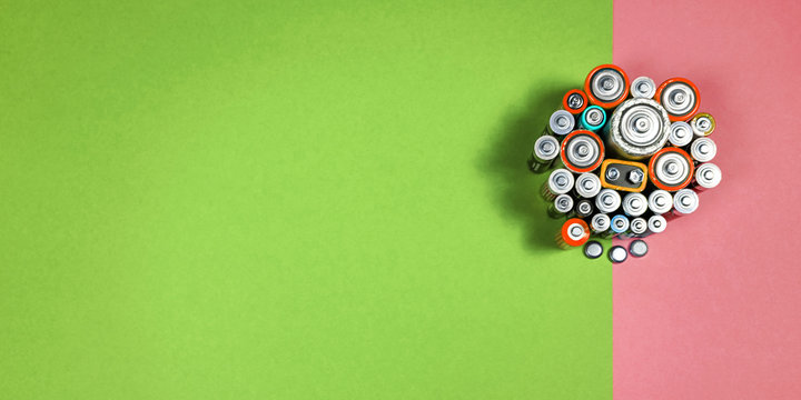 Many different types used or new battery, rechargeable accumulator, alkaline batteries on color background.