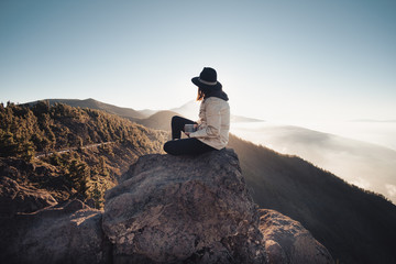 girl drinking coffee in the mountains