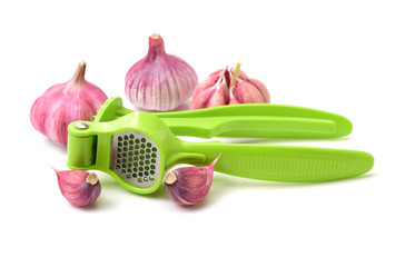 Garlic press and garlic on white background 