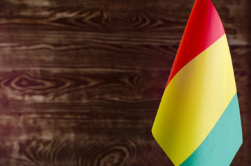 Fragment of the flag of the Republic of Guinea in the foreground space for text blurred background