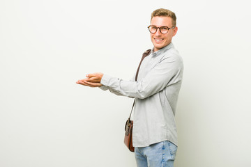 Young caucasian business man holding a copy space on a palm.