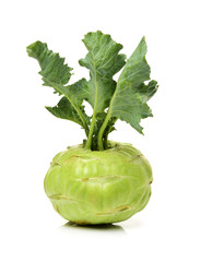 Fresh kohlrabi with green leaves on isolated white backround