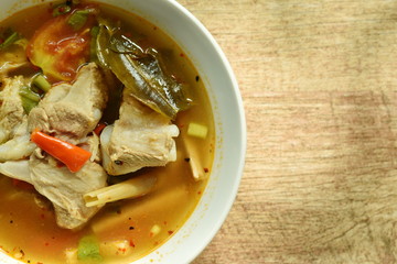 hot and spicy pork bone with tamarind and Thai herbs soup on bowl 