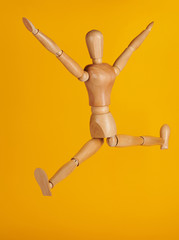 Wooden man in jumping pose