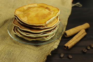 stack of pancakes, cinnamon on the table