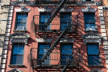Fototapeta na wymiar Fire Escape on a Red Brick Building on the Lower East Side of New York City