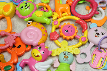 Fototapeta na wymiar children's colored toys, rattles on the table