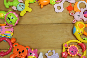 frame of toys on a wooden background