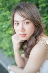 Fototapeta premium Asian beautiful women smiling in city public park morning light