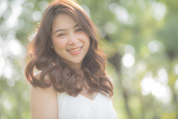Naklejka premium Asian beautiful women smiling in city public park morning light